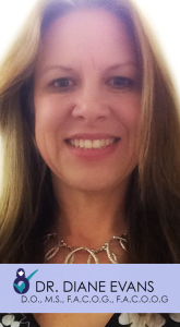 A woman with long hair and a necklace smiles for the camera.